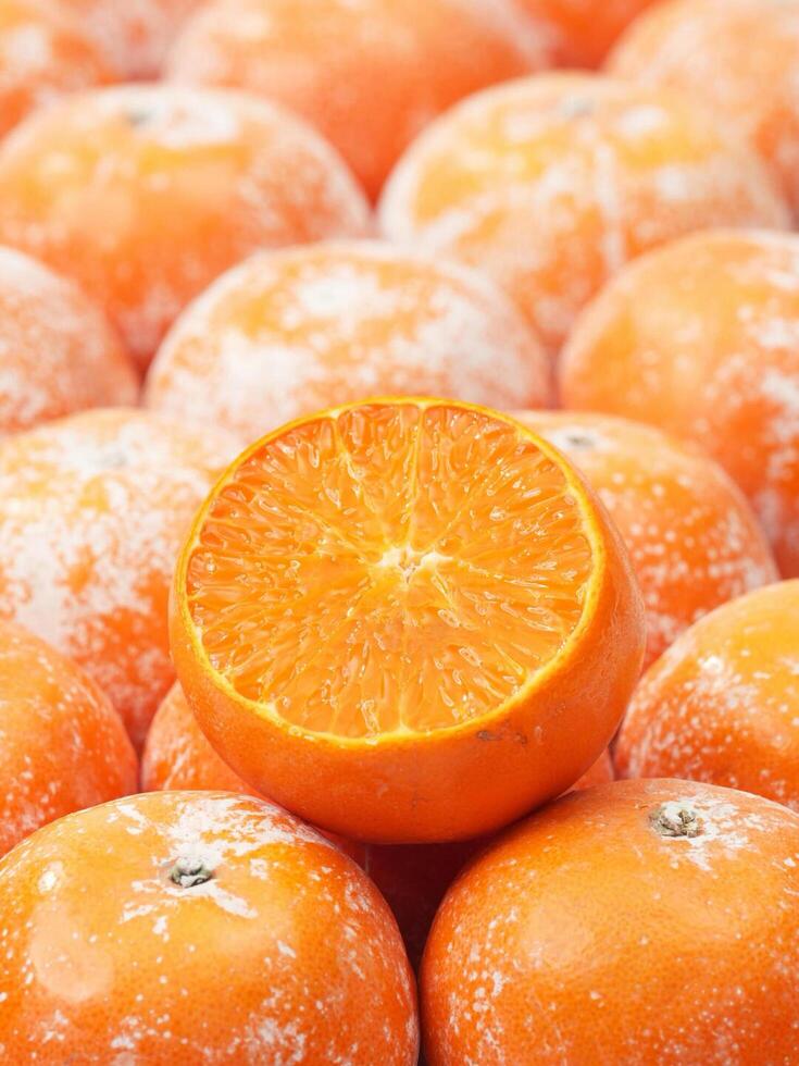 A pile of oranges, showcasing various types such as mandarin oranges, valencia oranges, and clementines.These fruits are part of the citrus family photo