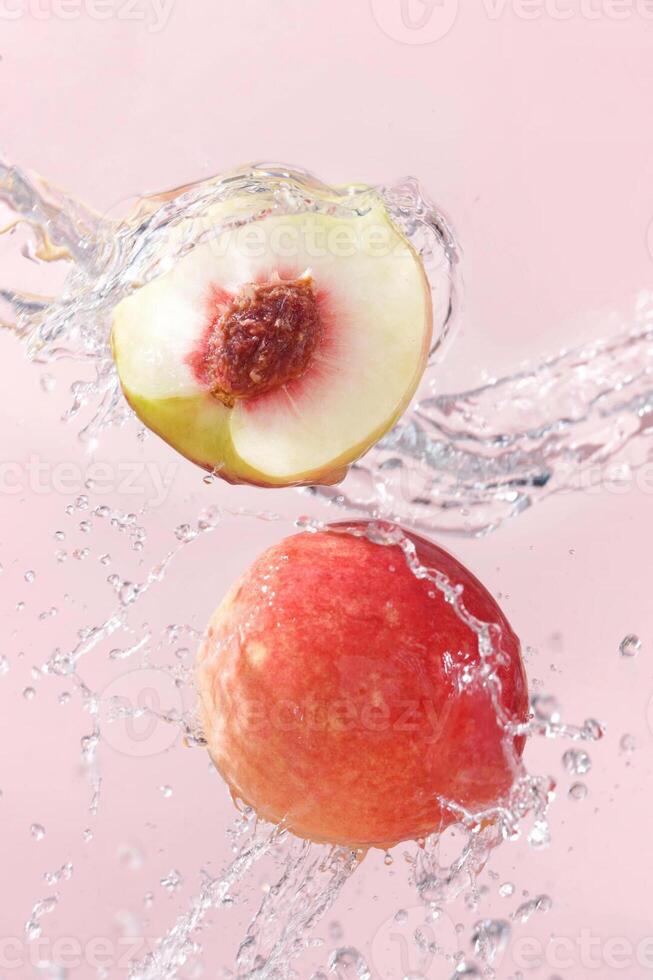 Peaches in water with splash photo