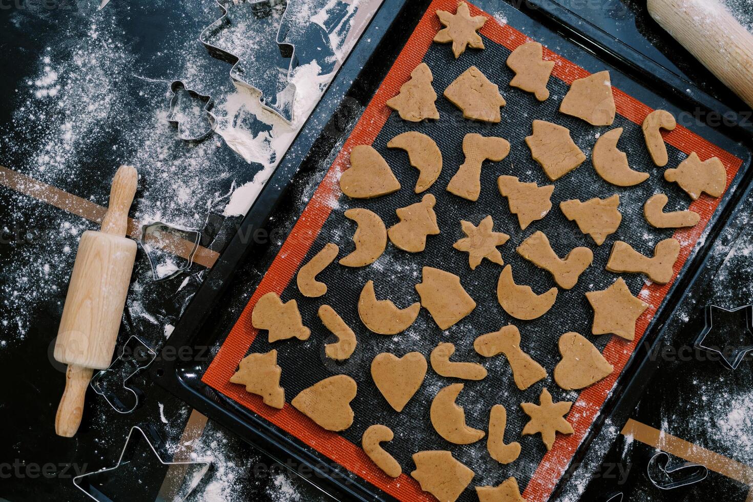 Unbaked Christmas cookies lie on a baking sheet on the table. Top view photo
