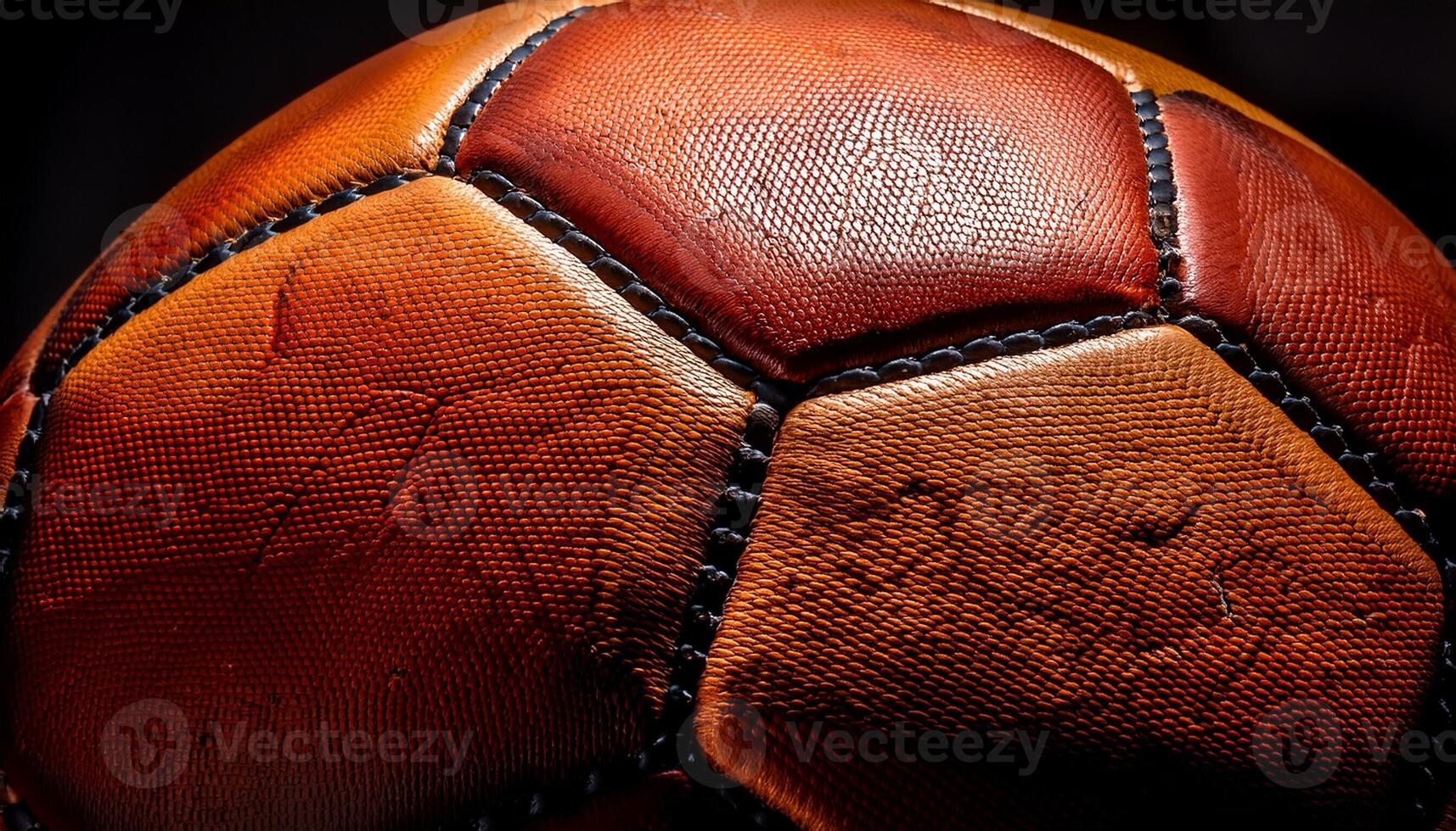 Close-up View of an Aged Soccer Ball Showing Intricate Texture and Stitches Under Dramatic Lighting photo