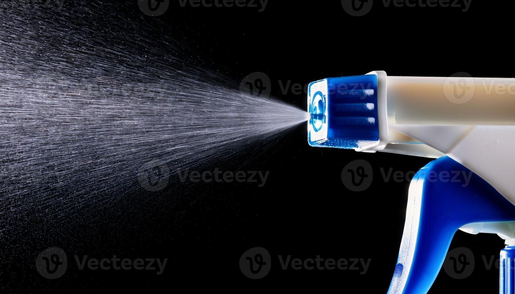 High-detail Close-Up of a Spray Nozzle Releasing Mist Against a Black Background Creating a Dynamic Visual Effect photo
