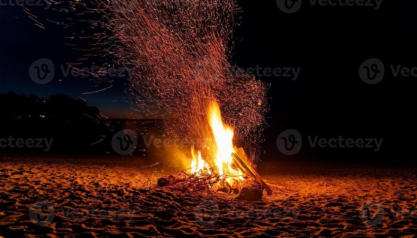 Nighttime Beach Bonfire Creates Glowing Sparks Under a Dark Sky While People Enjoy the Warmth and Ambiance of the Fire photo