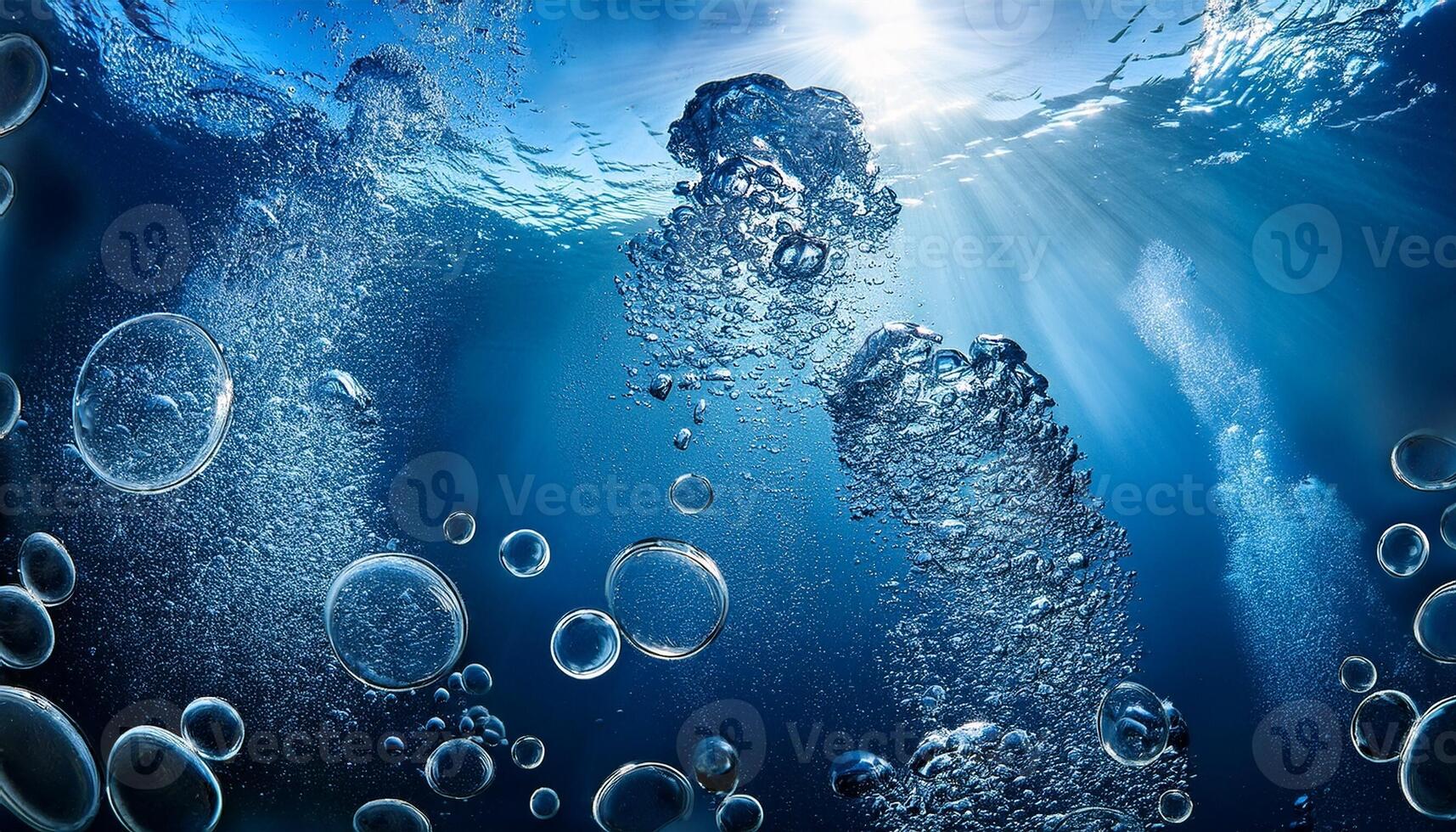 Underwater Bubbles Rise Towards the Surface as Sunlight Filters Through the Deep Blue Ocean photo