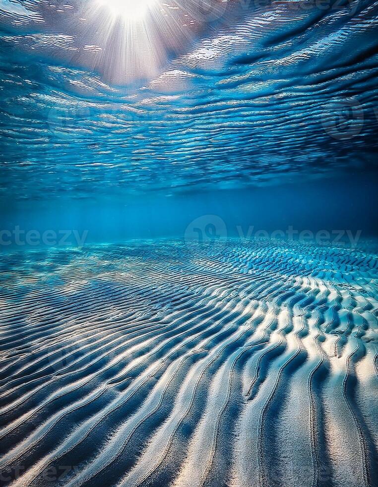 Sunlight Filters Through Water Creating Beautiful Patterns on Sandy Ocean Floor in Vibrant Underwater Scene photo