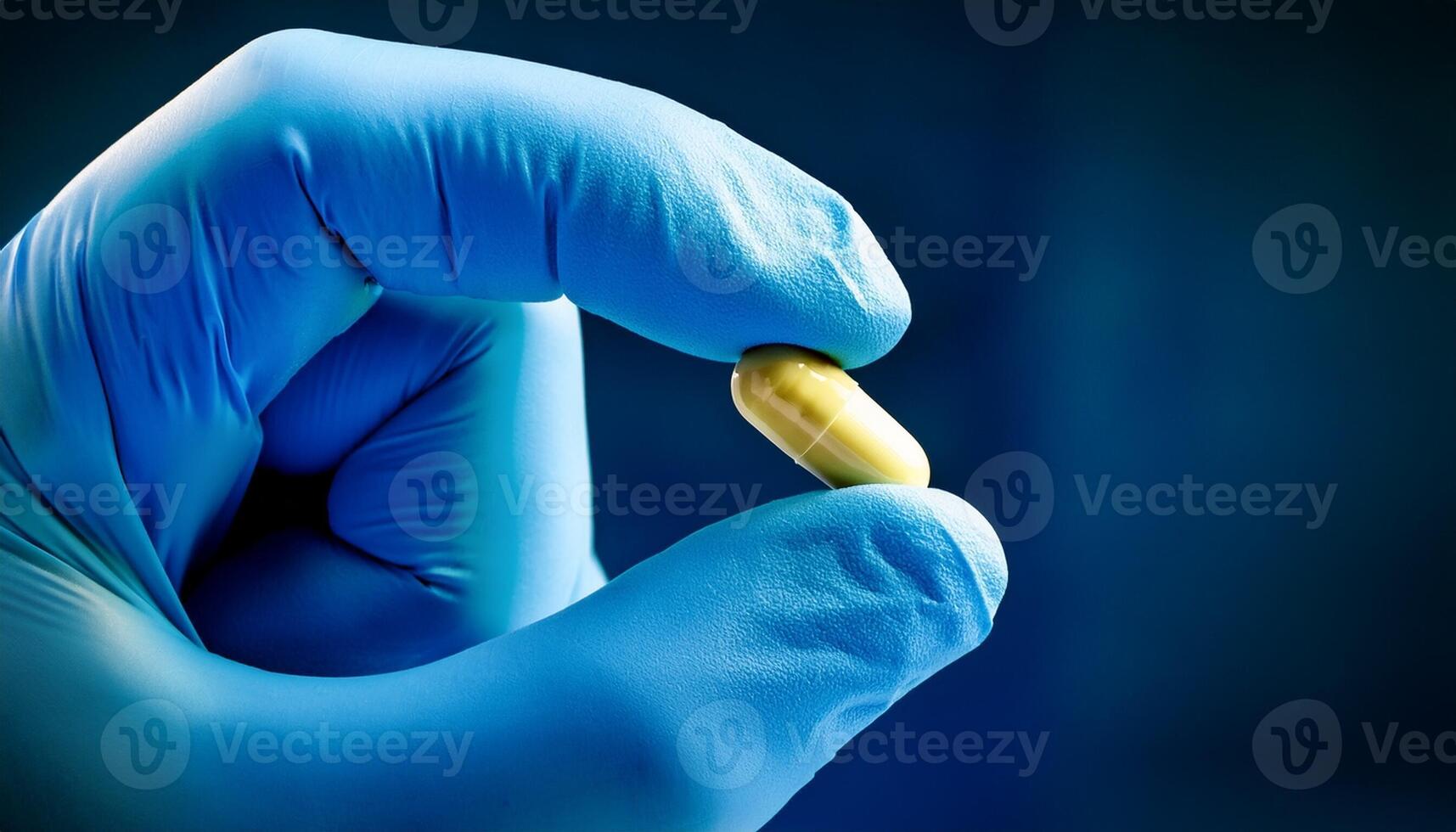 Hand in Gloves Holding a Yellow Capsule Against a Dark Background in a Laboratory Setting photo