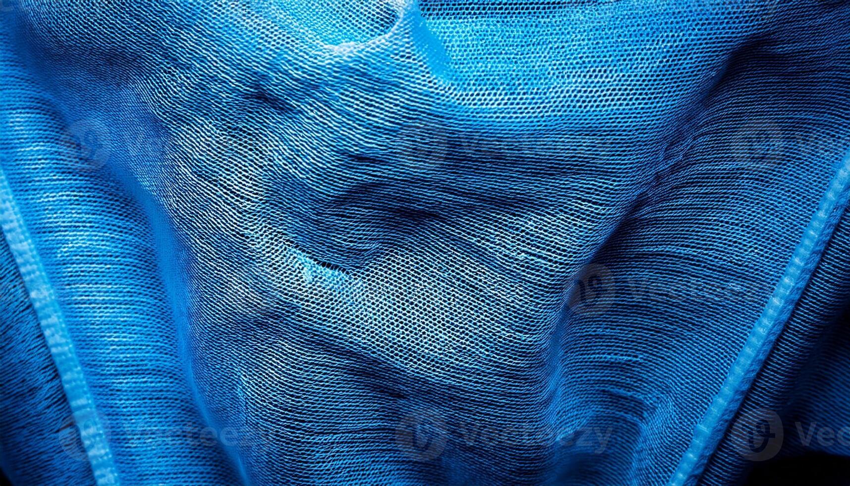 Textured Blue Fabric Close-Up Showcasing Intricate Woven Patterns and Varying Shades of Blue During Daylight photo