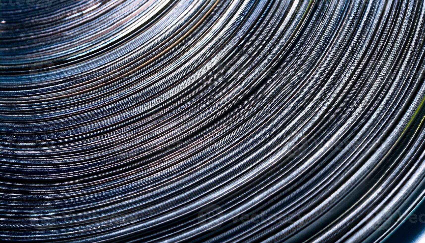 Close-up View of Swirling Metallic Lines Showcasing Intricate Patterns and Reflecting Light in an Abstract Design photo