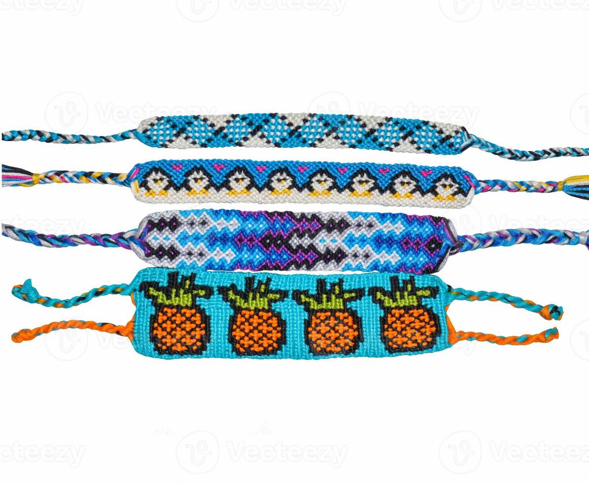 Woven friendship bracelets with blue patterns. Handmade of floss thread, isolated on white background. photo