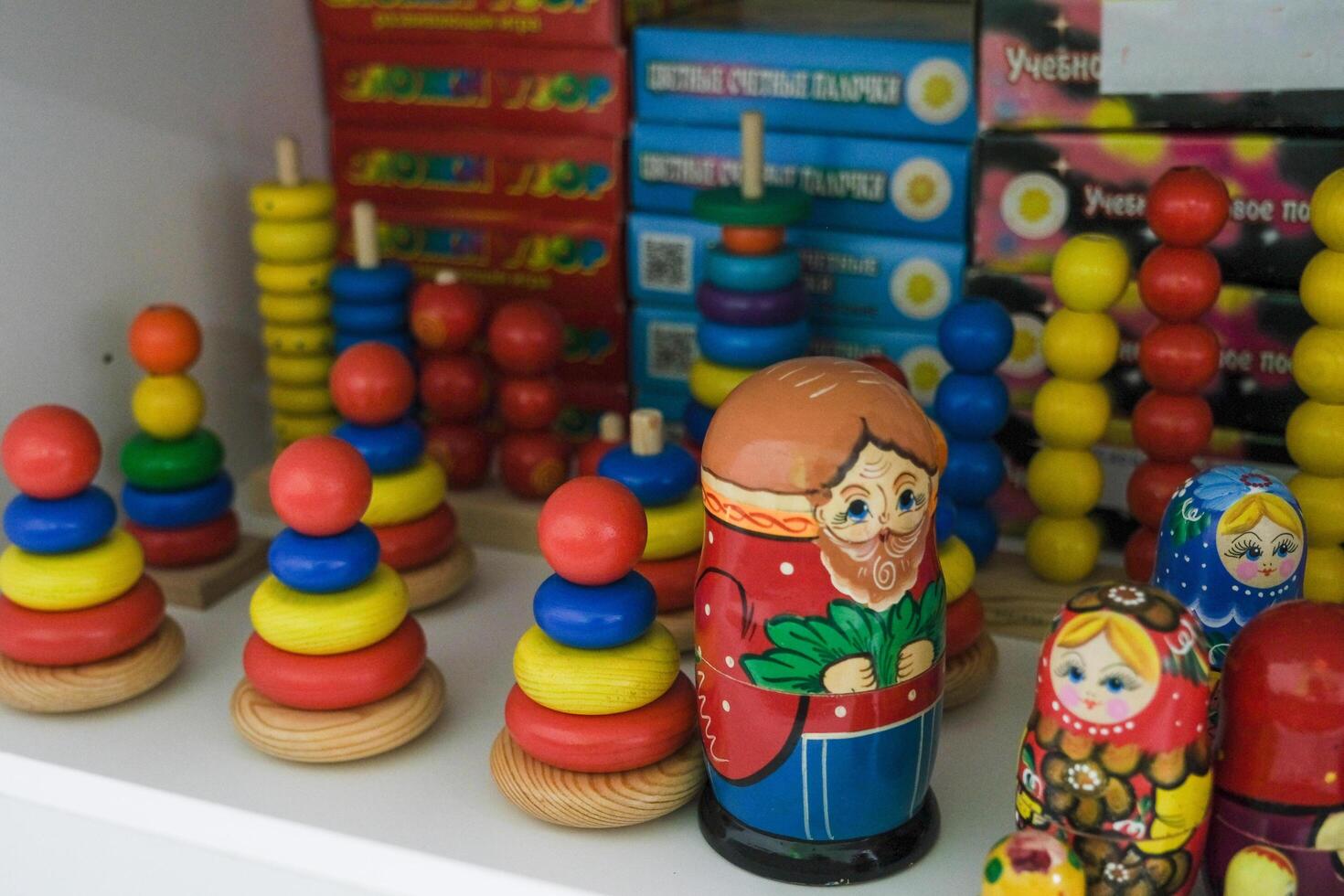 many wooden multi-colored pyramids standing on a shelf photo