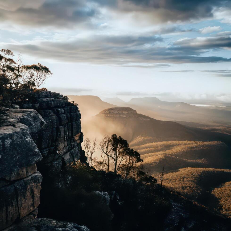 The sun shines on a mountain range with trees and rocks photo