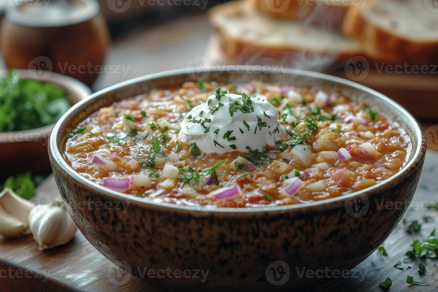 a steaming bowl of Ukrainian borscht, topped with a dollop of sour cream, served with rye bread and garlic, with a rustic wooden background and warm lighting photo