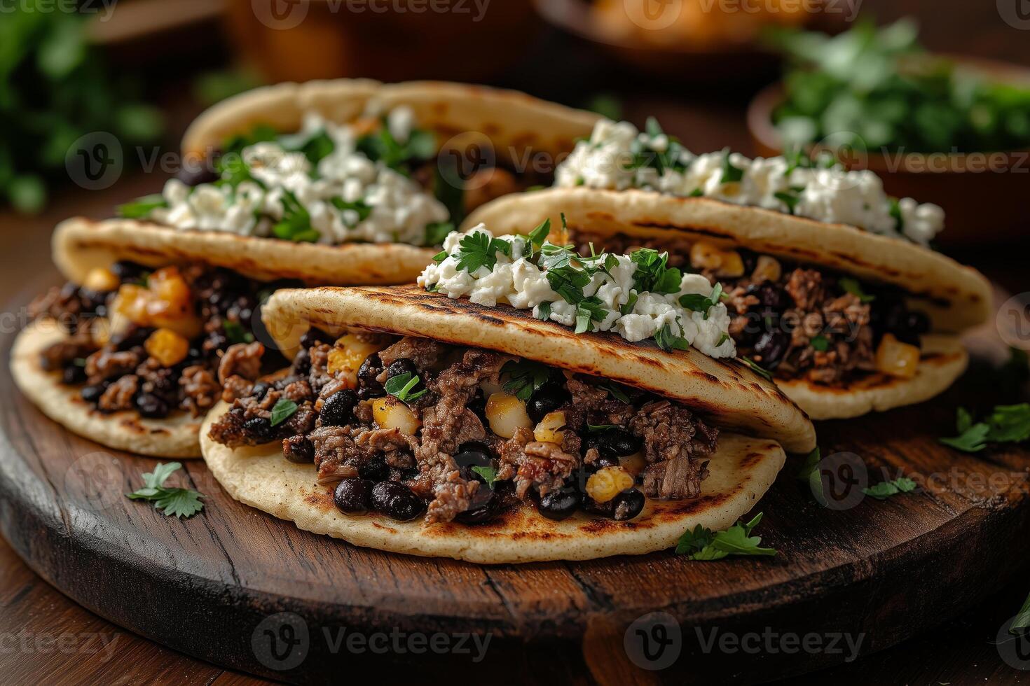 Venezuelan arepas filled with shredded beef, black beans, and cheese, arranged on a rustic wooden plate, with vibrant background details and natural light photo