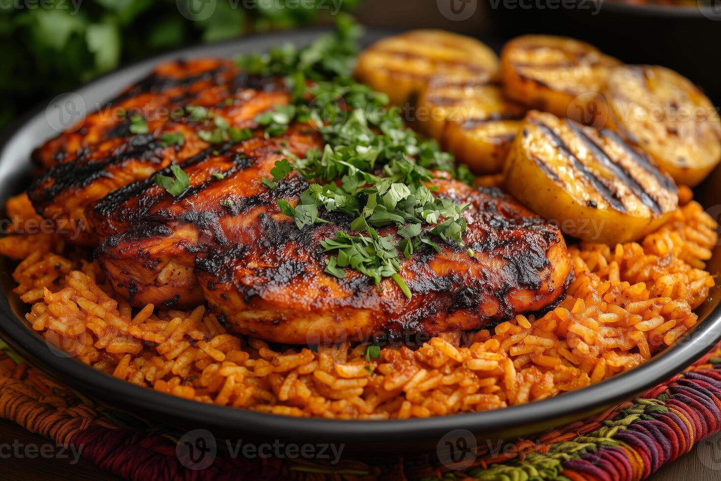 a traditional African meal featuring jollof rice, served with grilled chicken and fried plantains, garnished with fresh herbs, set on a colorful woven mat photo