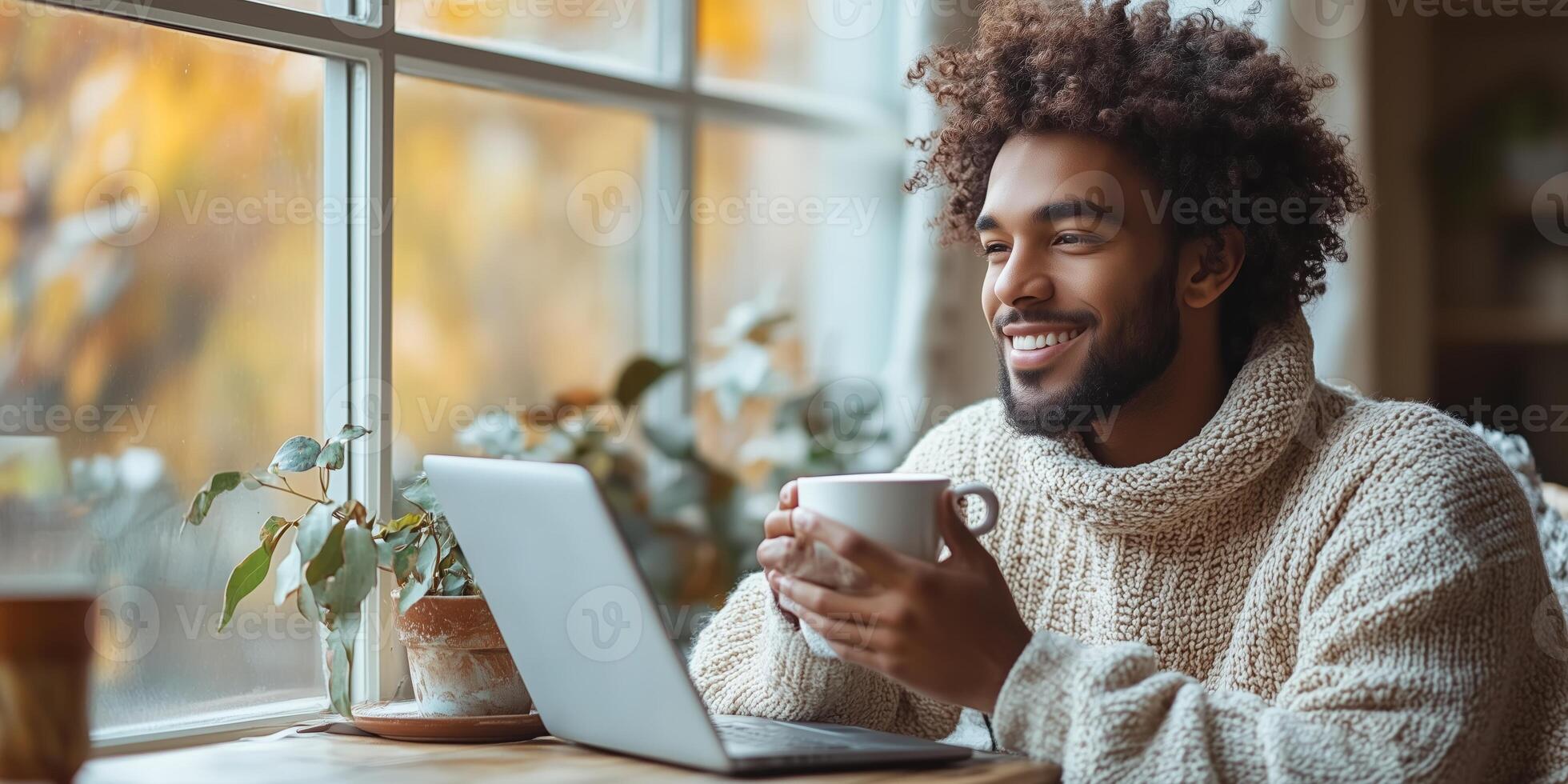 a man savoring his morning coffee while working on his laptop, minimalist workspace with copy space on the right, calm natural light photo