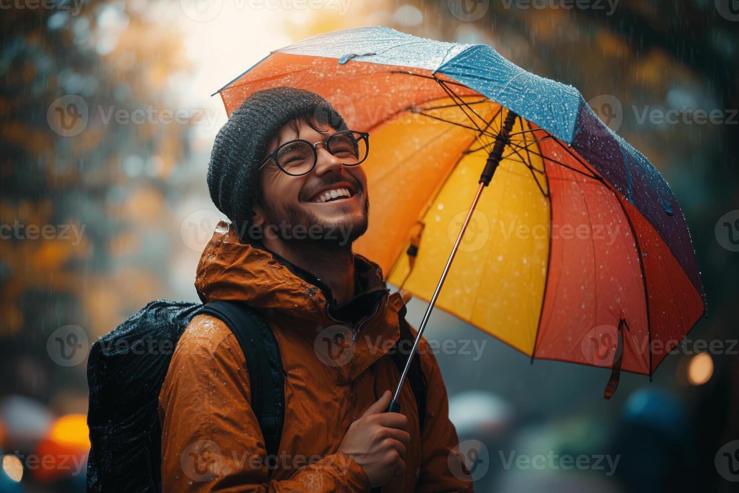 a man laughing as he walks through a park in the rain, holding a colorful umbrella, vibrant greenery in the background, soft diffused light photo