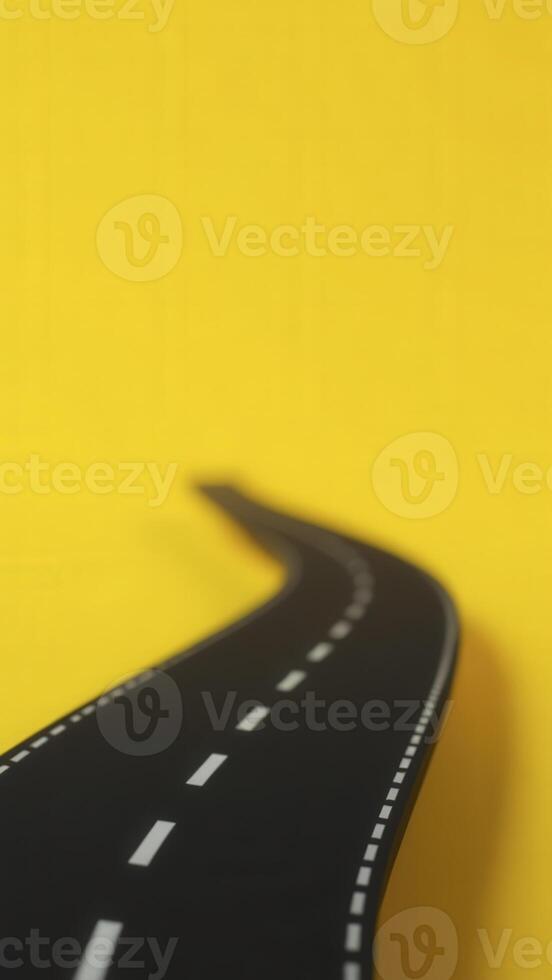 Winding road leading into the unknown on yellow background photo
