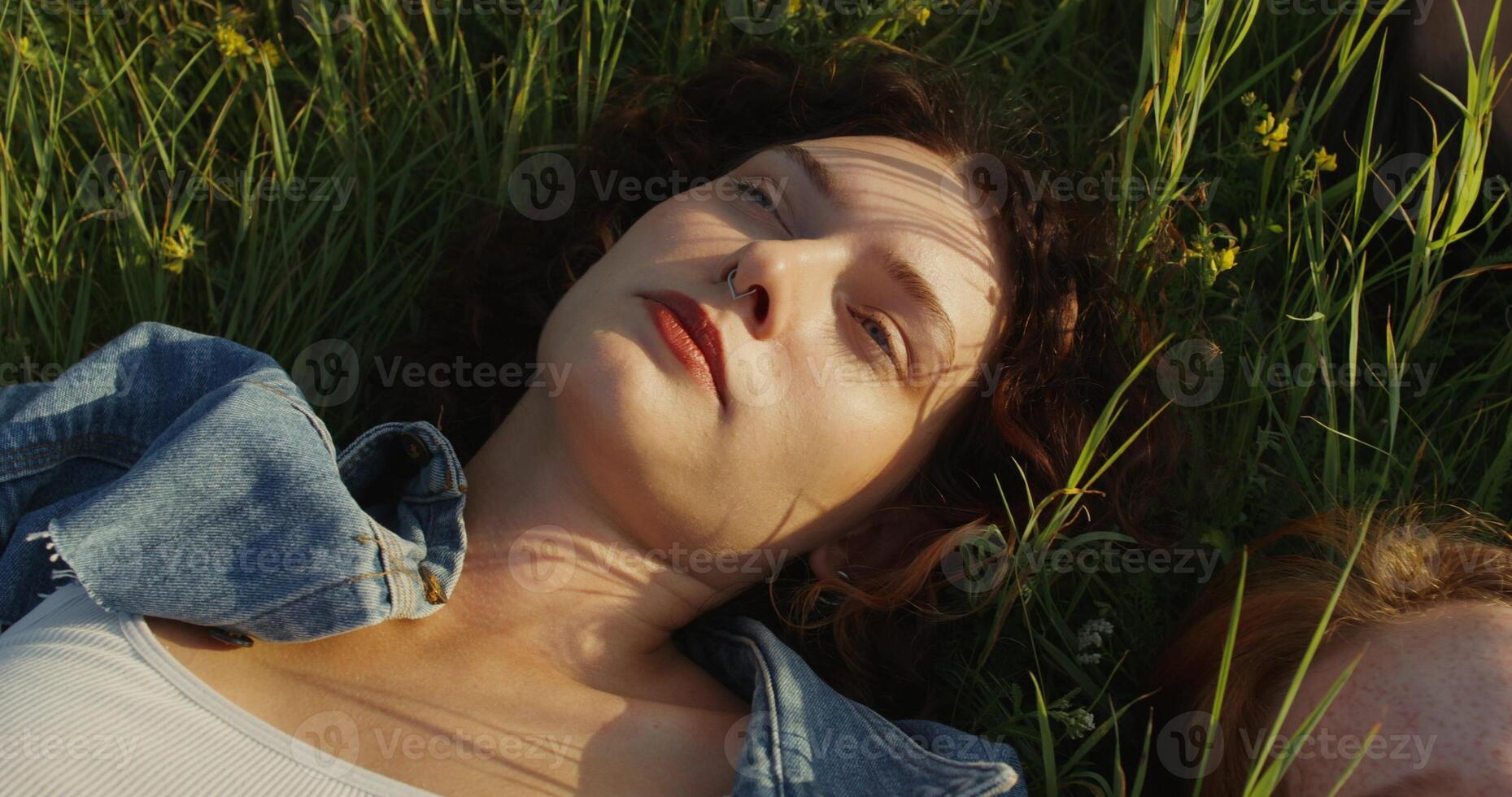 A woman laying in the grass photo