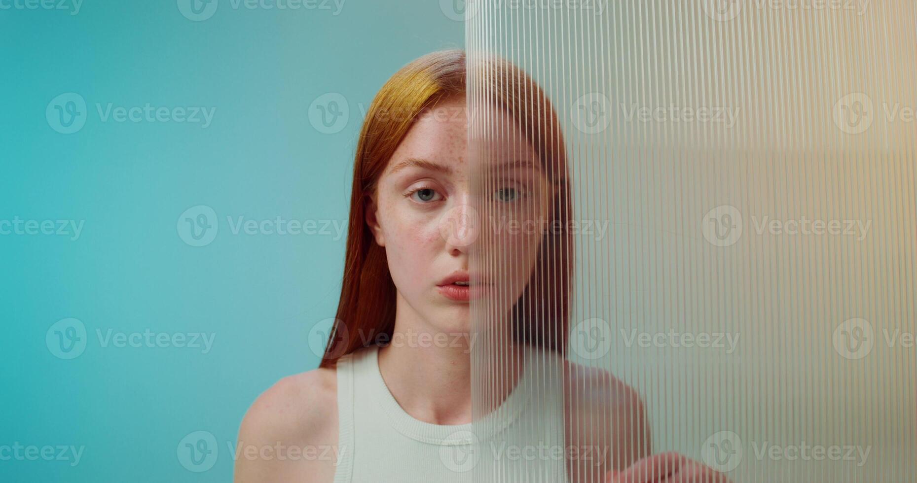 A woman with red hair standing in front of a mirror photo