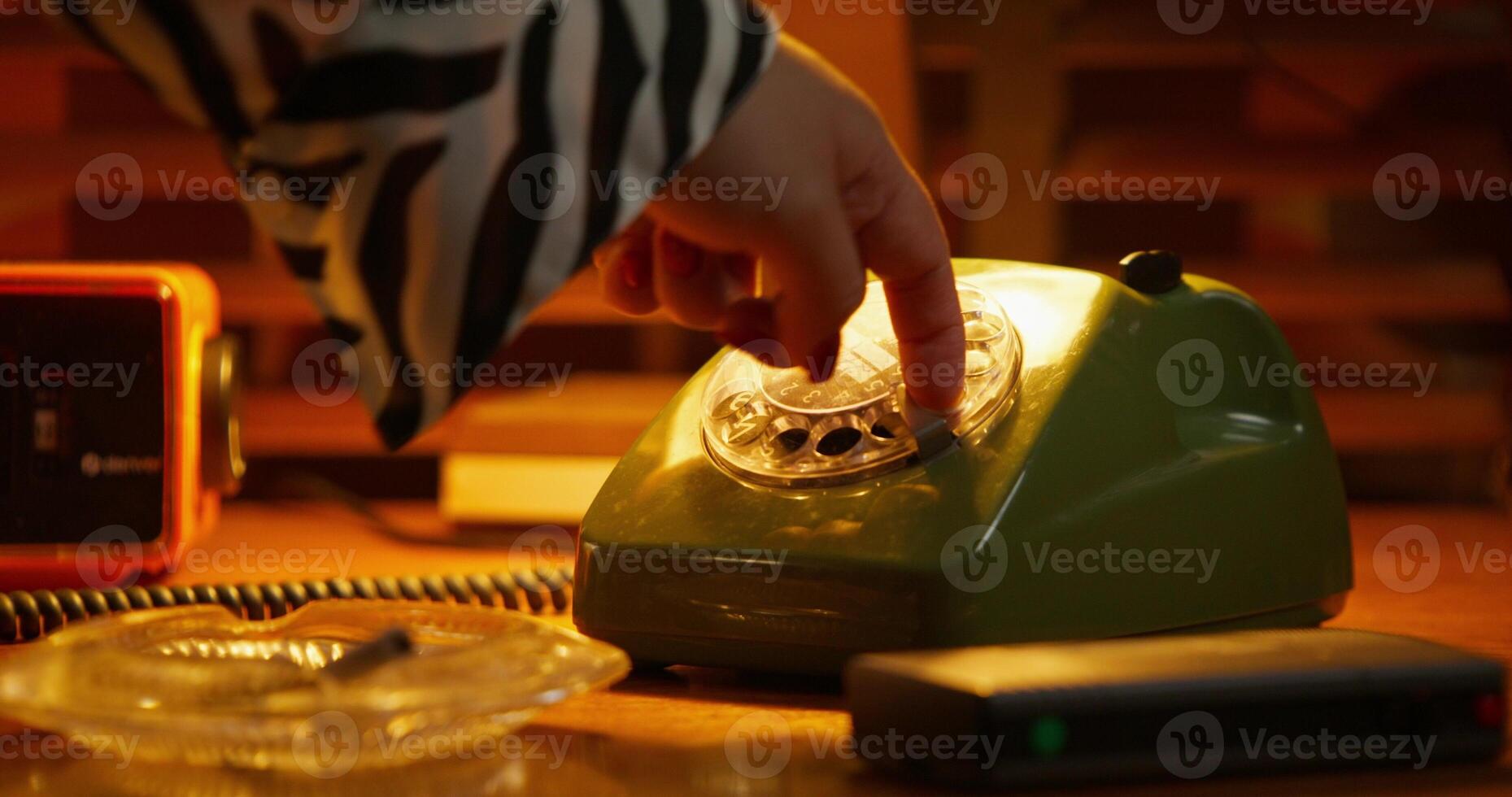 A person is touching a green telephone photo