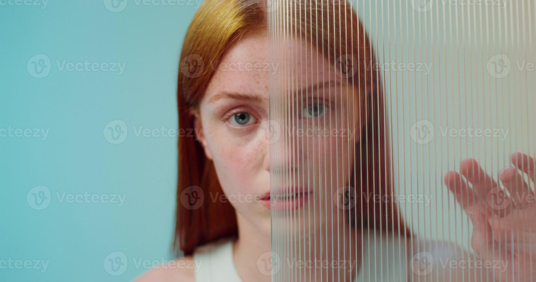 A woman looking through a glass window photo
