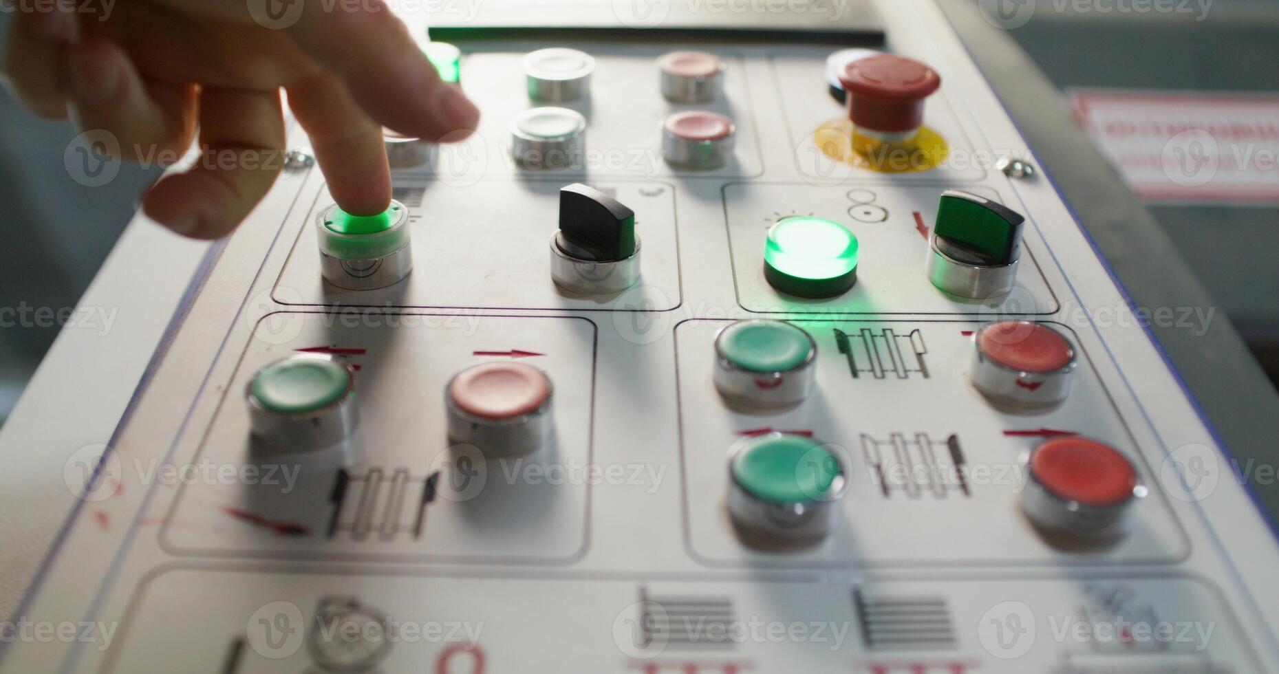 A person is touching a control panel on a machine photo