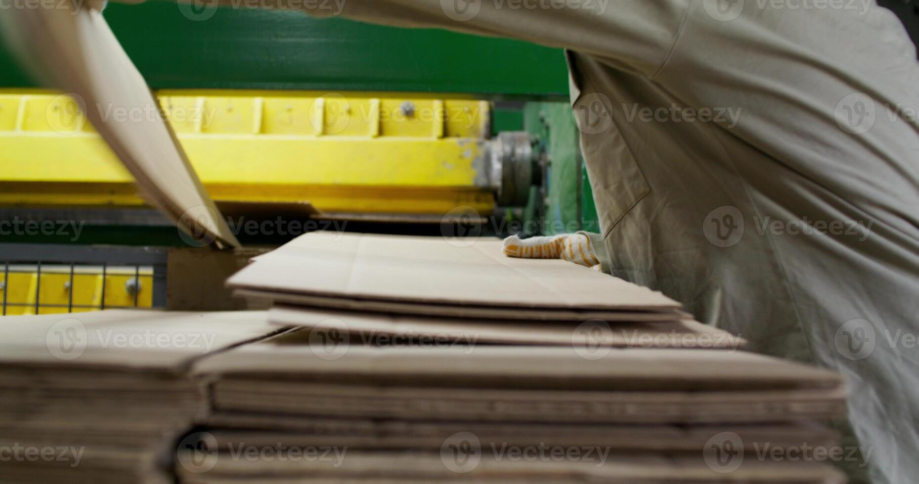 A man is working on a stack of paper photo