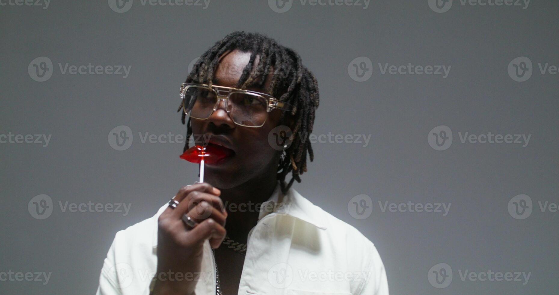 A man eats a lollipop photo