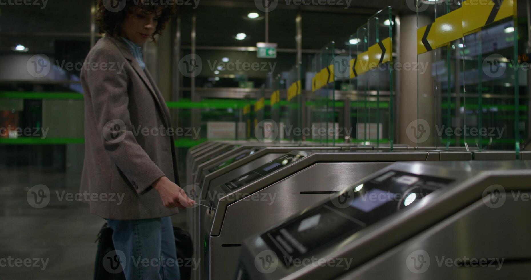 A woman is standing in front of a machine photo
