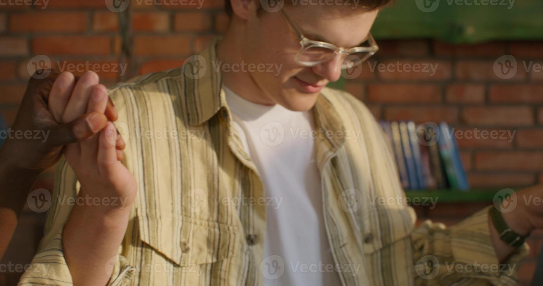 A man in glasses and a striped shirt photo