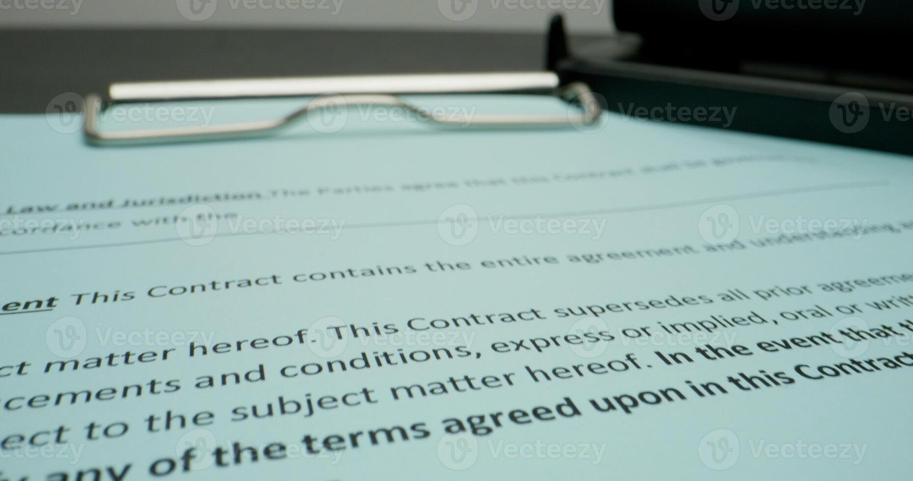 A contract is signed by a lawyer and a pen photo