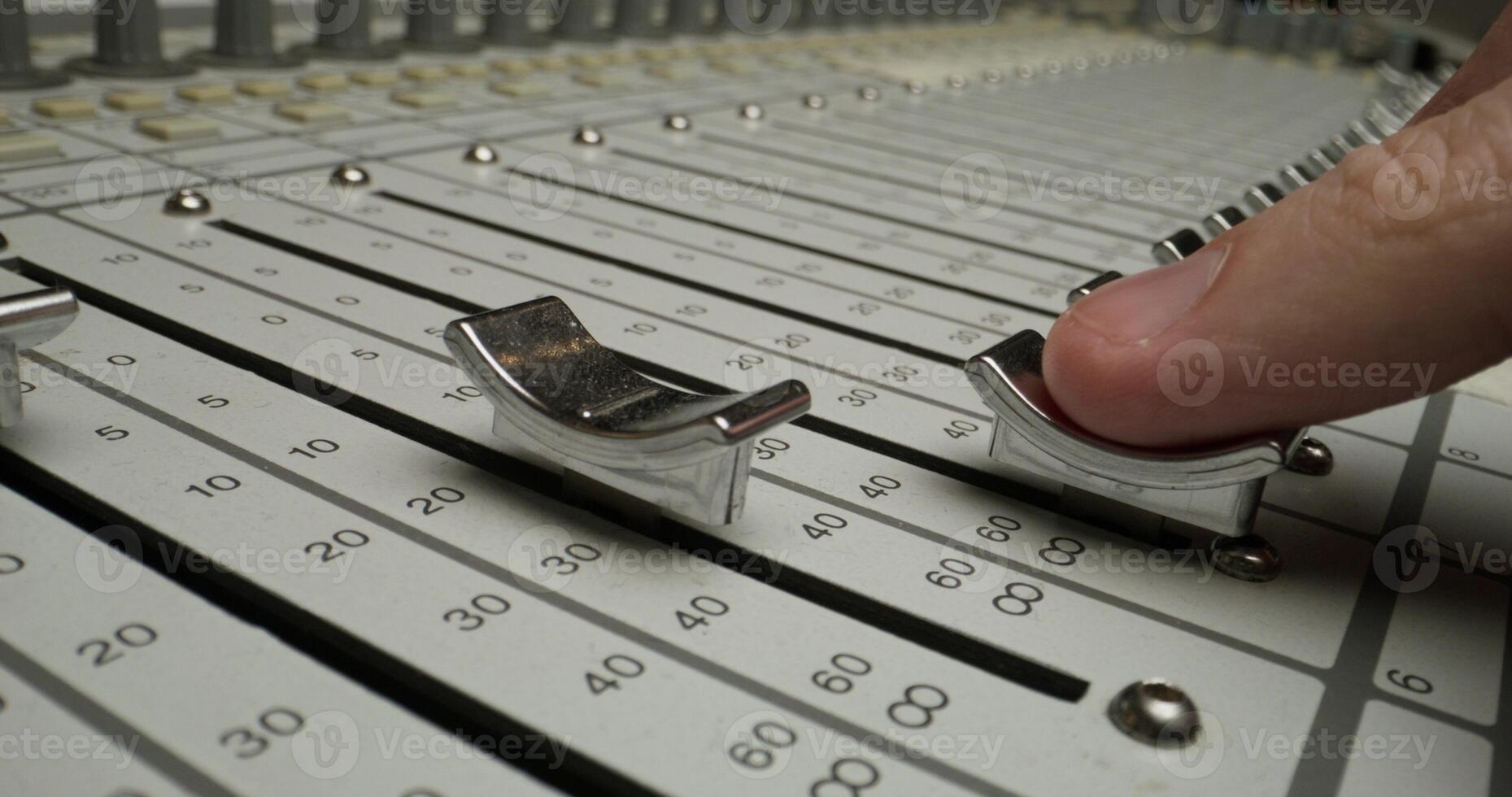 A person is touching a sound mixer photo