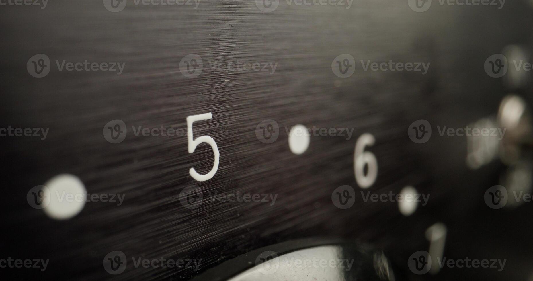 A close up of a black dial with numbers on it photo