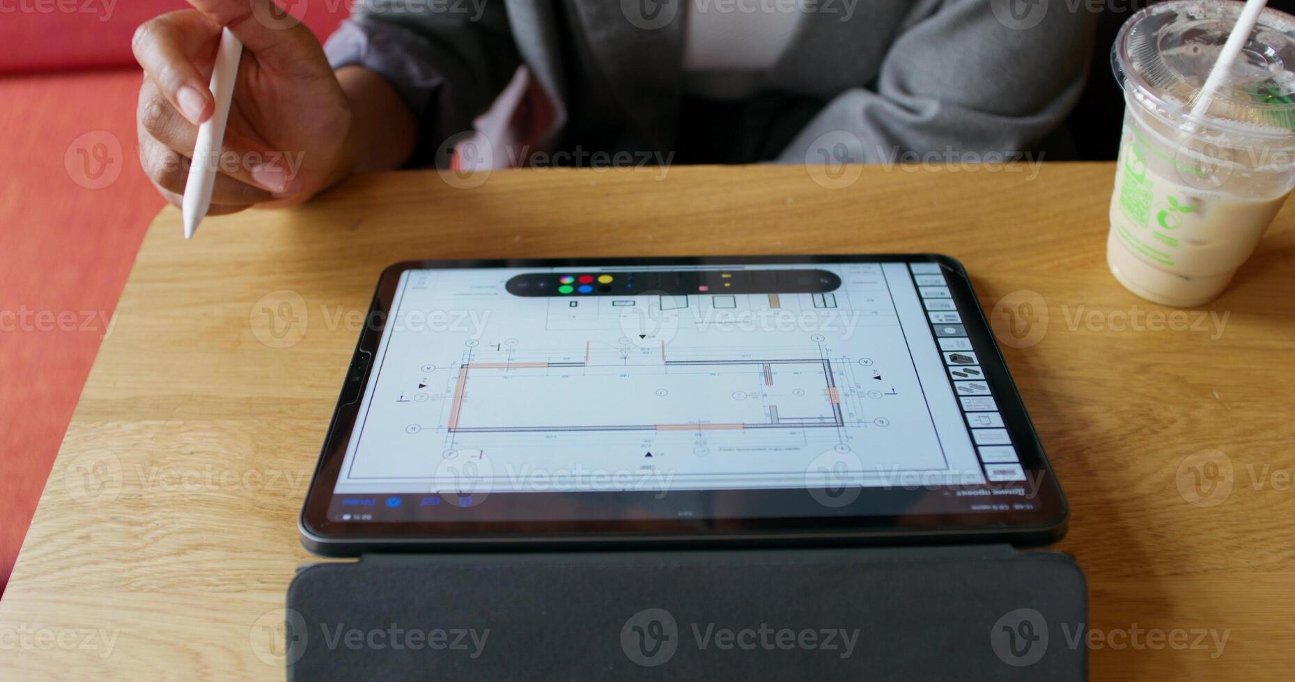 A person holding a pen and a tablet computer photo