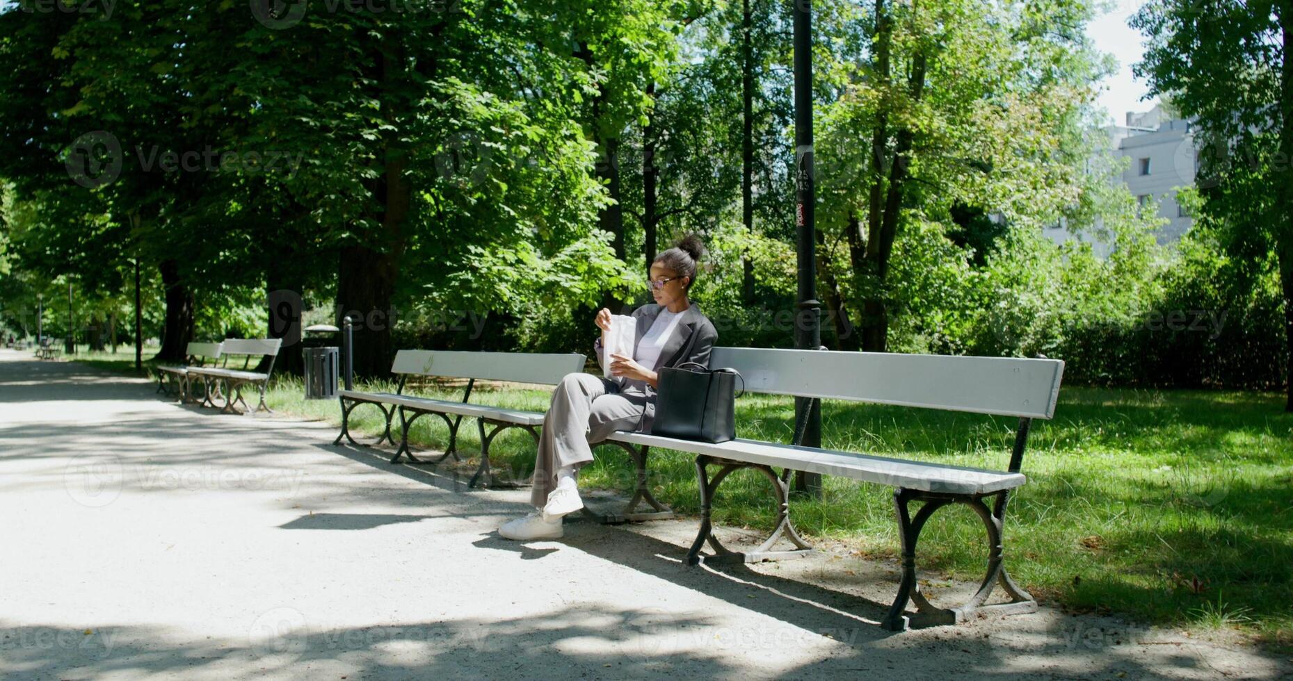 A man sitting on a bench in a park photo