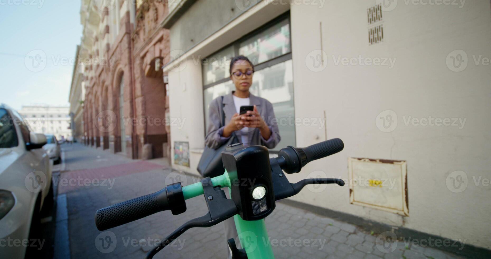 A woman on a bike looking at her phone photo