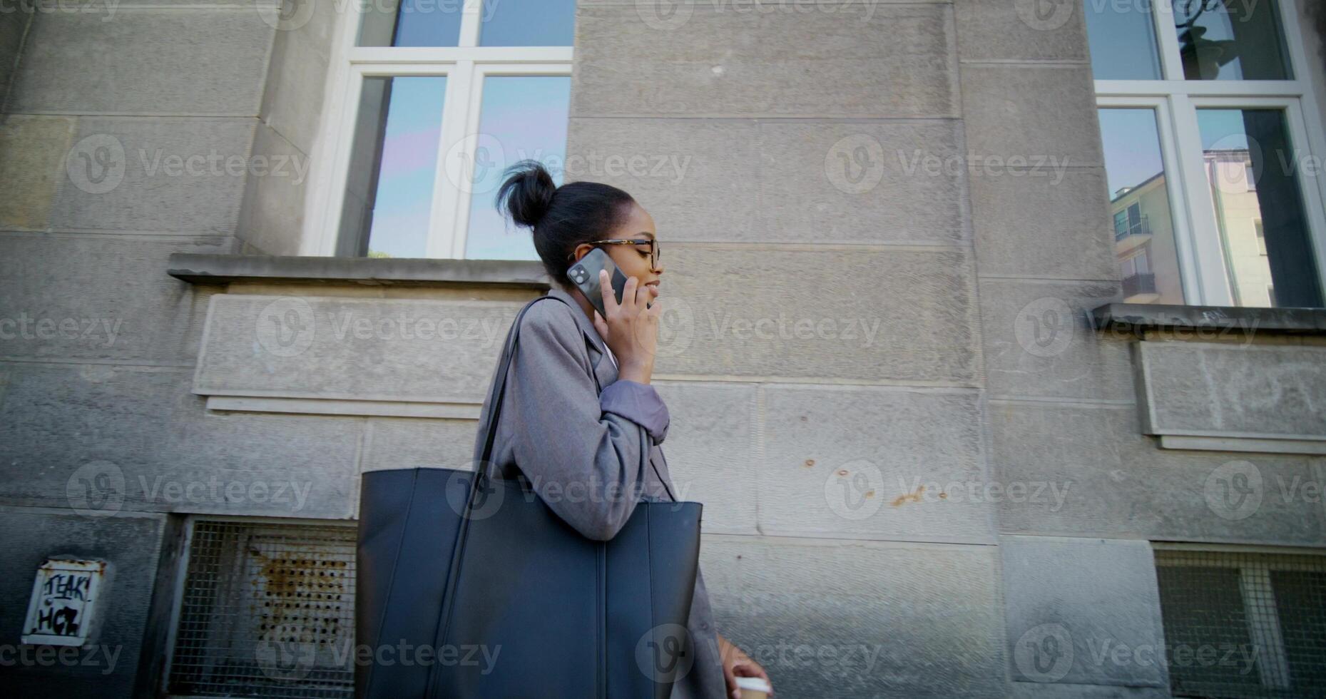 A woman talking on a cell phone while walking photo