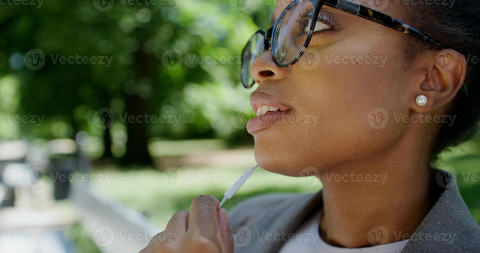 A woman in glasses is looking at something photo