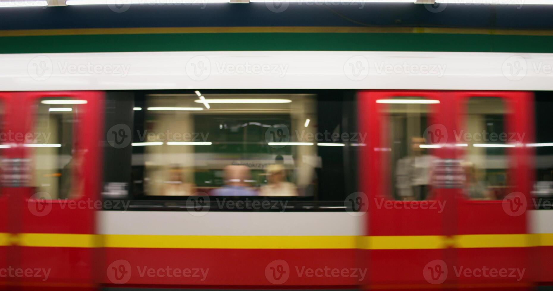 A blurry image of a train moving through a station photo