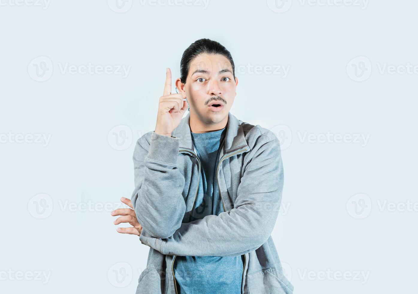 Surprised guy pointing a promotion up isolated. Surprised asian man pointing a discount up on isolated background photo