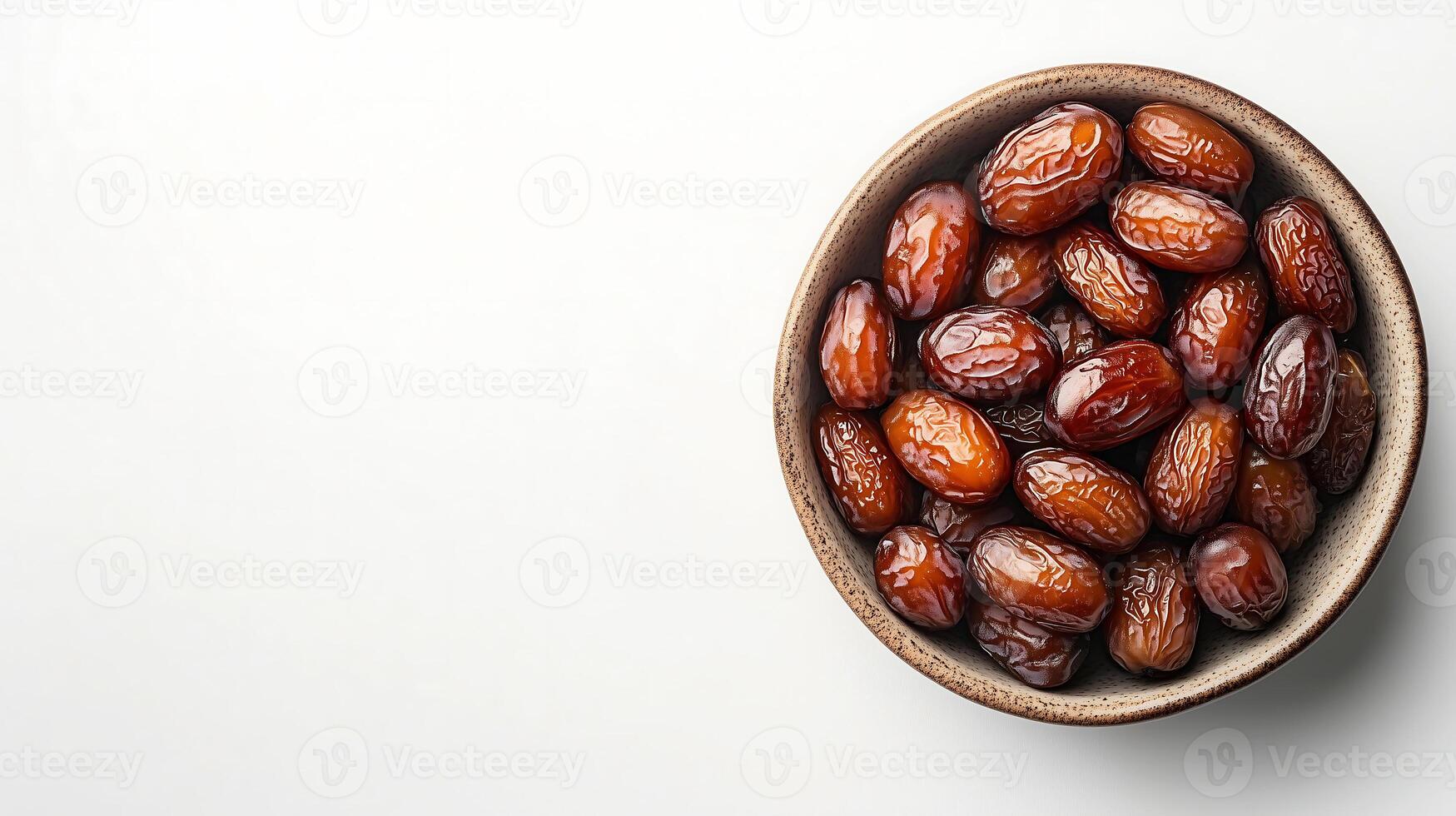 dates in a bowl on a white background photo