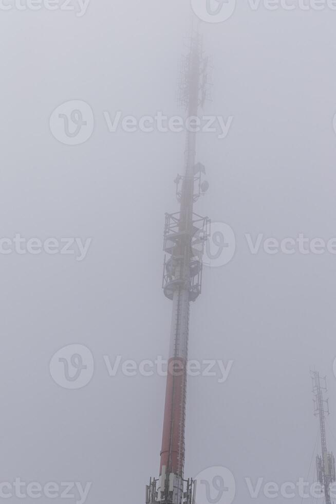 Cell tower in the mountains during fog Poland photo