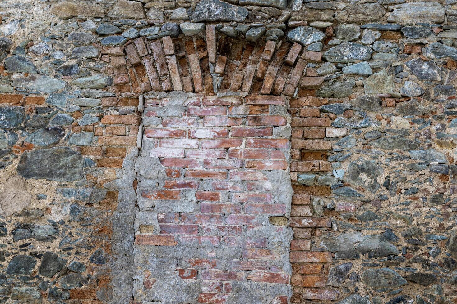 Ancient ruins, an ancient window in an ancient brick wall of a monastery, bricked up.. Komarno, Poland photo