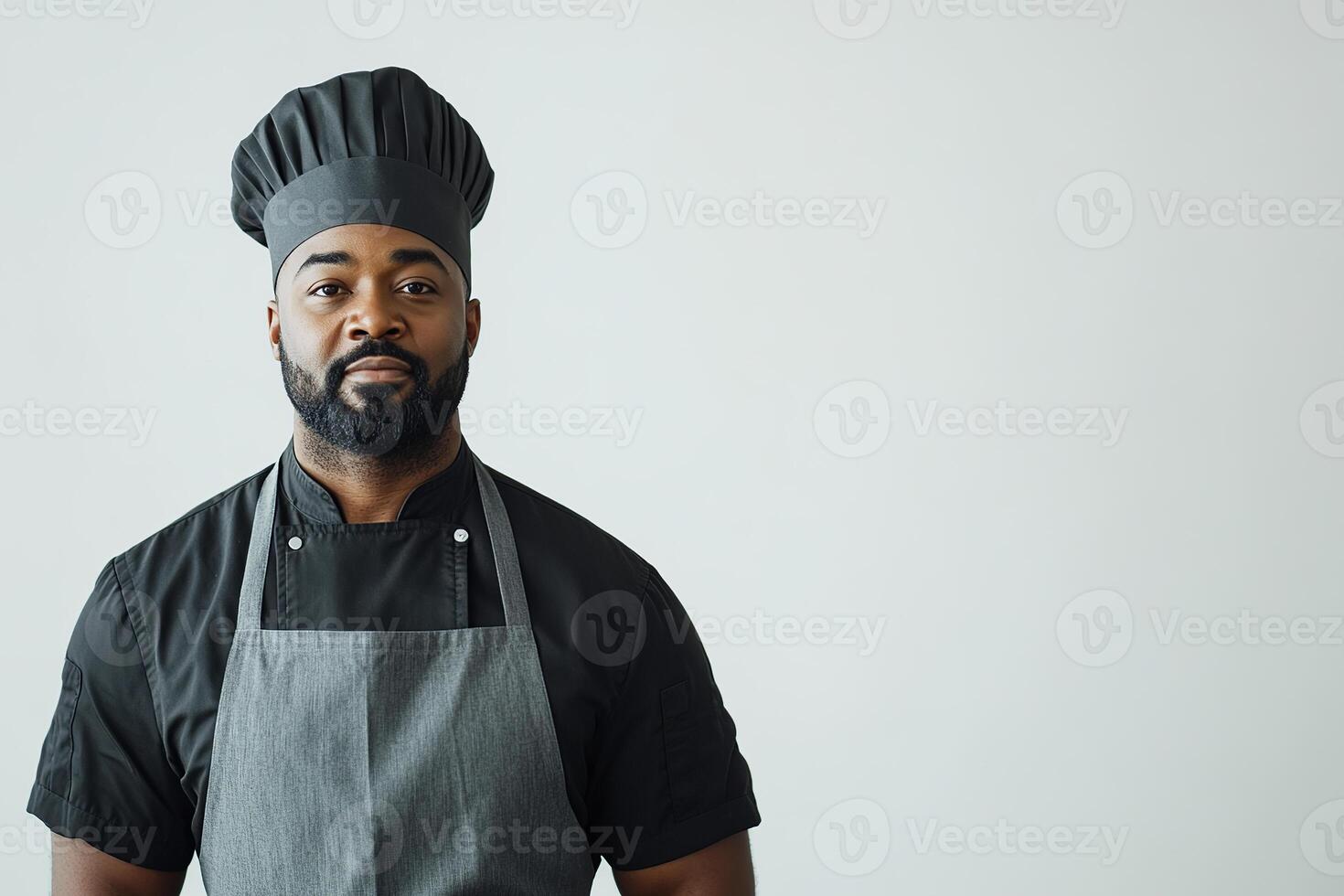 Chef in uniform and apron against neutral background. Copy space photo