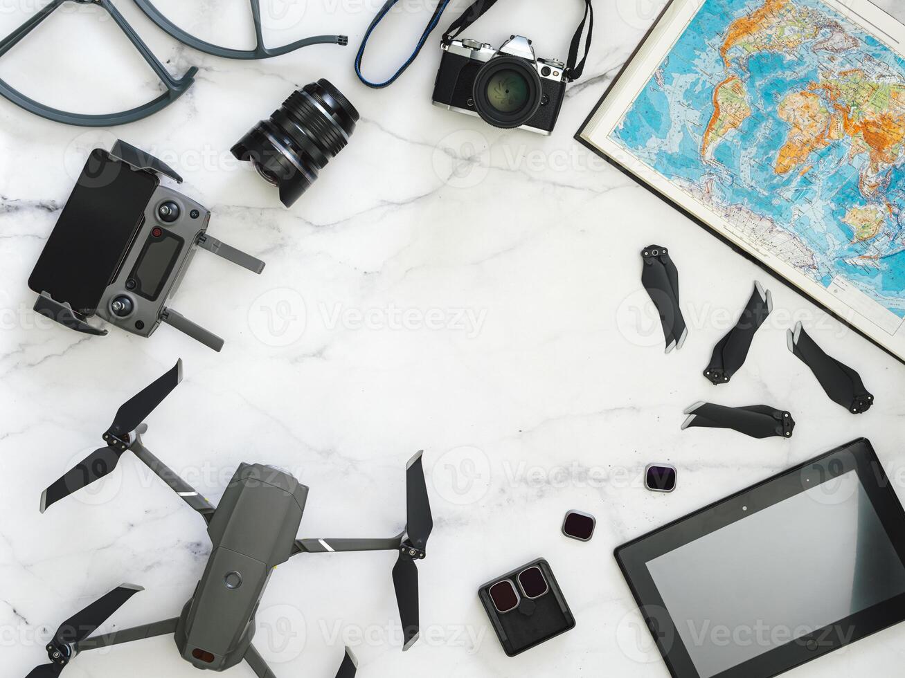 Travel concept with copy space. Drone, camera and map, top view or flat lay photo