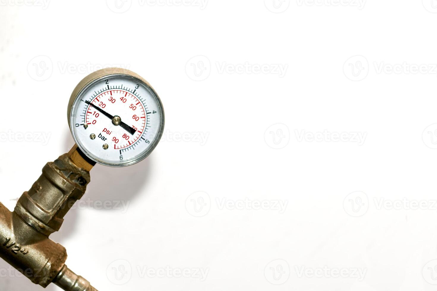 Hot water temperature sensor in a basement plumbing system on white photo
