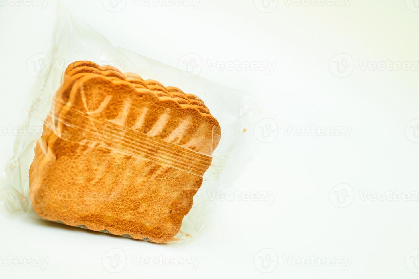 Sweet sugar cookies in a protective cellophane package for sale on a white photo