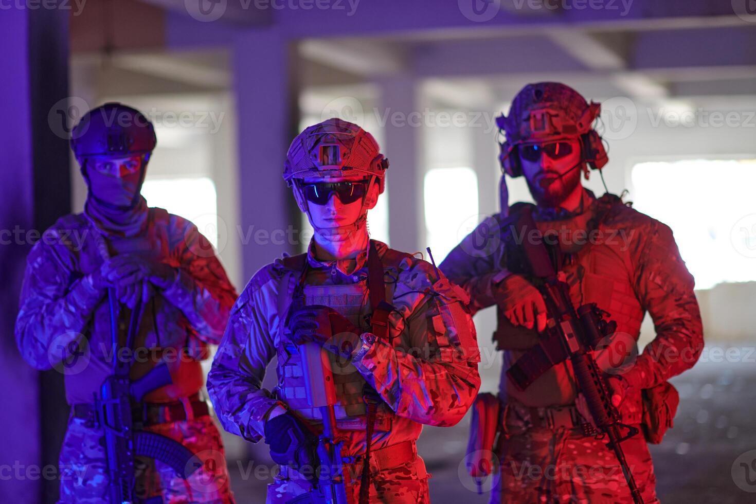 Soldier squad team walking in urban environment colored lightis photo