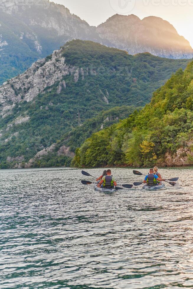A group of friends enjoying having fun and kayaking while exploring the calm river, surrounding forest and large natural river canyons photo