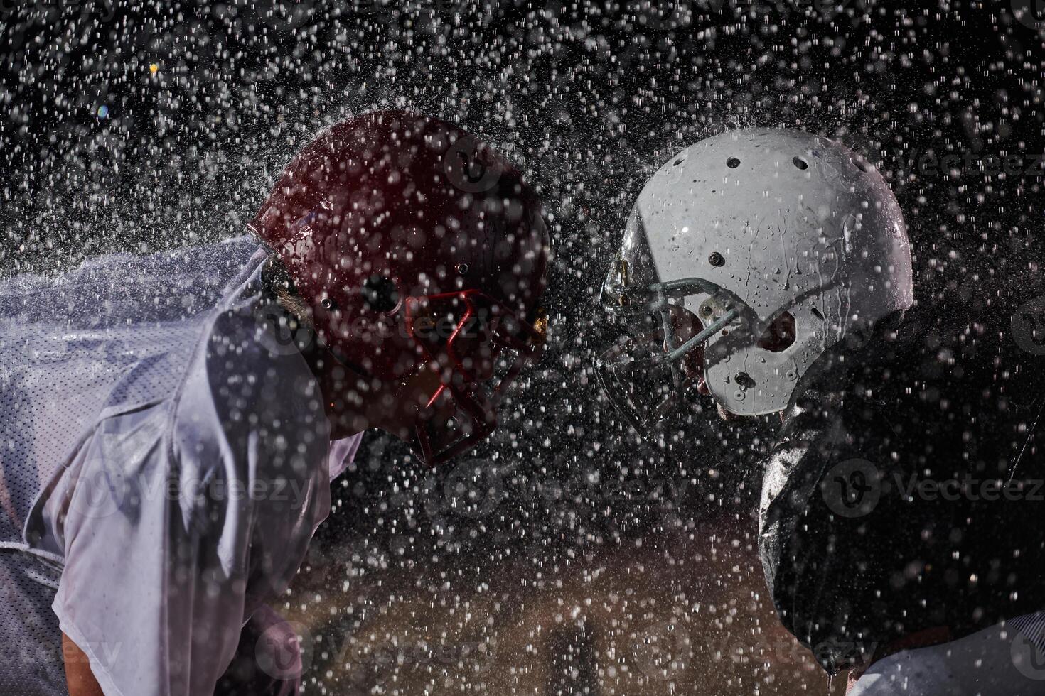 Two american football players face to face in silhouette shadow on white background photo