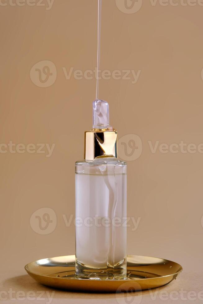 A bottle of cosmetic product with a pouring texture on top. photo